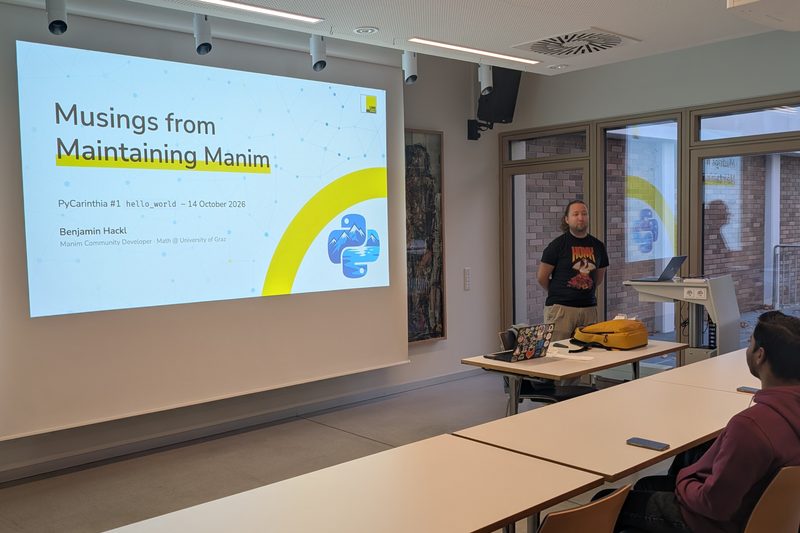 Benjamin Hackl next to his title slide, Musings from Maintaining Manim