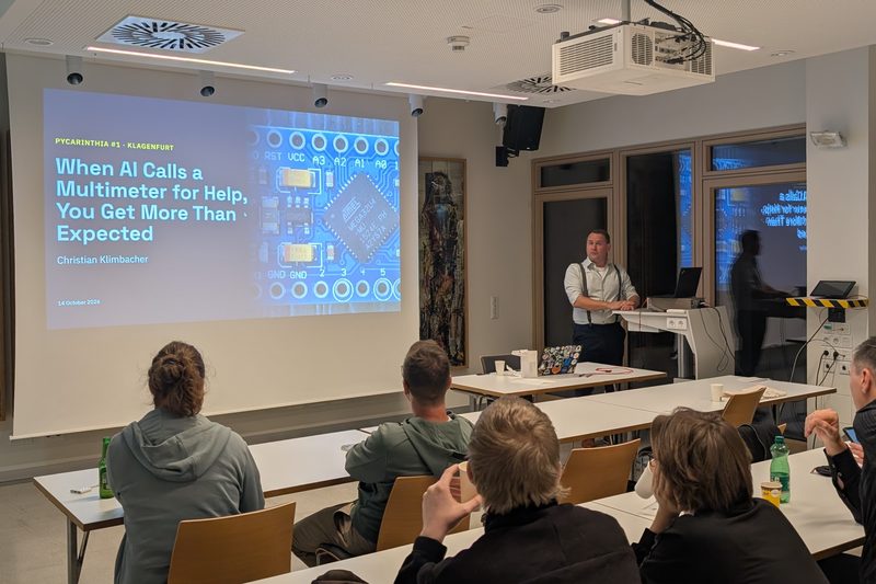Christian Klimbacher beside his title slide, When AI Calls a Multimeter for Help