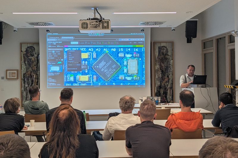 Christian Klimbacher showing his circuit board analysis tool on the projector