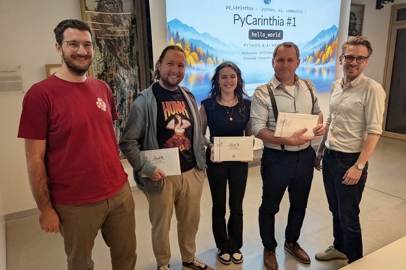 Organiser Harald Nezbeda, speakers Benjamin Hackl, Alina Nessel and Christian Klimbacher, and organiser Gabriel Lipnik in front of the PyCarinthia #1 title slide